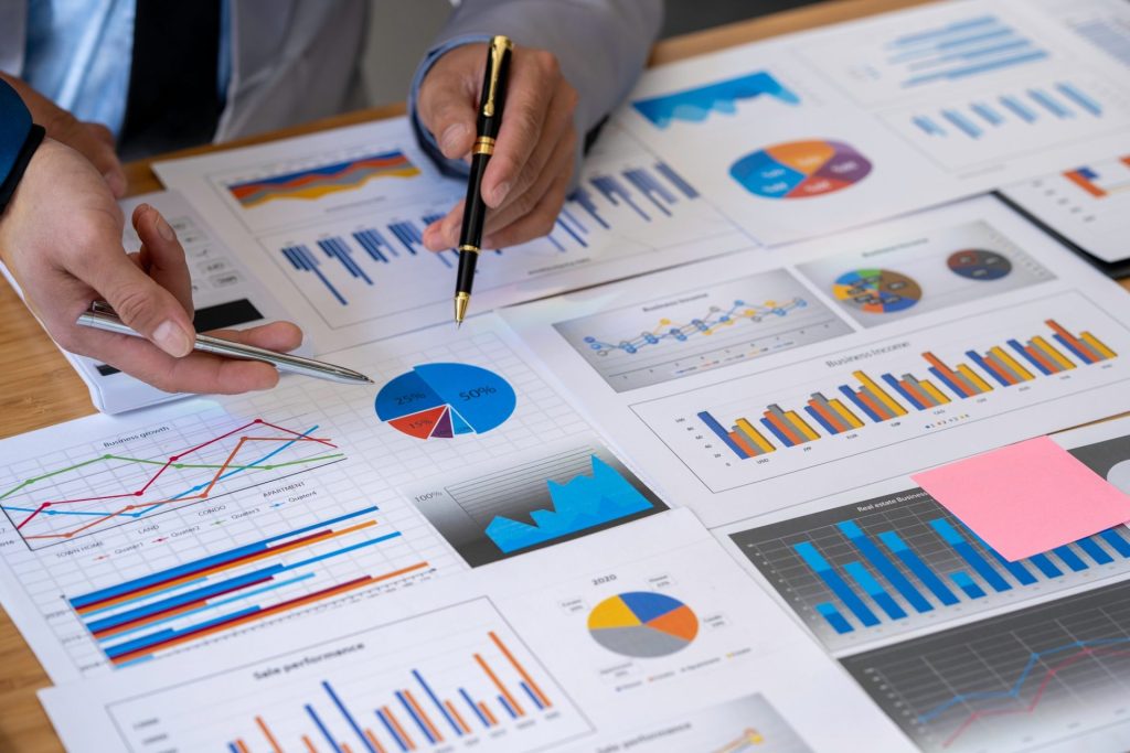 Analyzing results, business people are meeting to analyze data for the marketing plan. Concept of fi